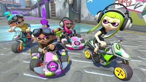 Inklings in Mario Kart 8 Deluxe / Four inklings from the Splatoon game series, two on motorcycles and two in karts, race on a circuit in Mario Kart 8 Deluxe. / Image credit: Nintendo