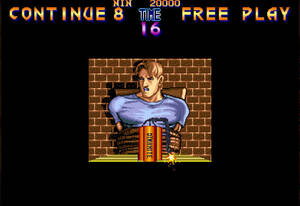 Final Fight continue screen / 16-bit game graphics with a man tied to a chair with dynamite strapped to his front. Text reads "CONTINUE 8", "TIME 16", and "FREE PLAY". / Image credit: Capcom