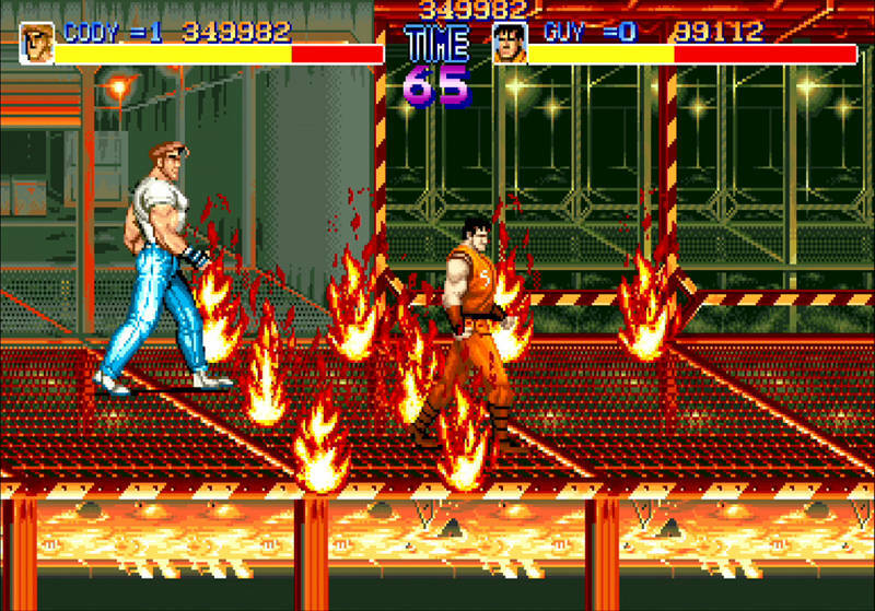 Final Fight: Guy and Cody walk through fire / Two men, one in T-shirt and jeans and other with an orange sleeveless gee, walk through fireballs on a steel mesh walkway. / Image credit: Capcom