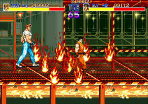 Final Fight: Guy and Cody walk through fire / Two men, one in T-shirt and jeans and other with an orange sleeveless gee, walk through fireballs on a steel mesh walkway. / Image credit: Capcom