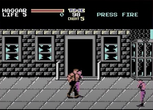 Final Fight for Commodore 64 / 8-bit video game screenshot with a street brawl between a shirtless wrestler and two thugs. This image is a cropped screen grab from a Digital Foundry YouTube video. / Image credit: Capcom